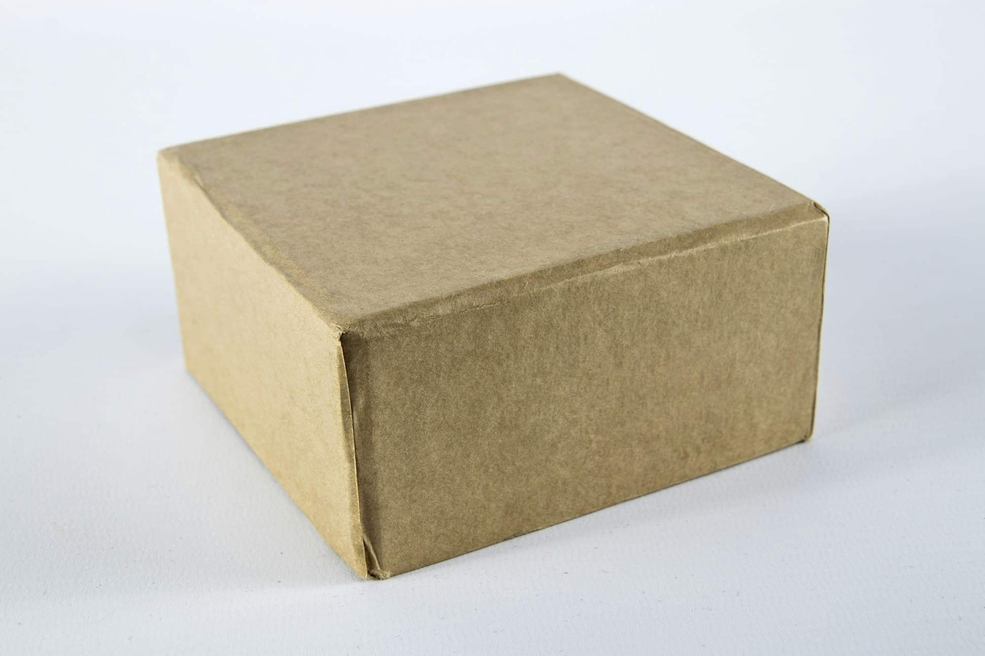 A brown cardboard shipping box on a white surface